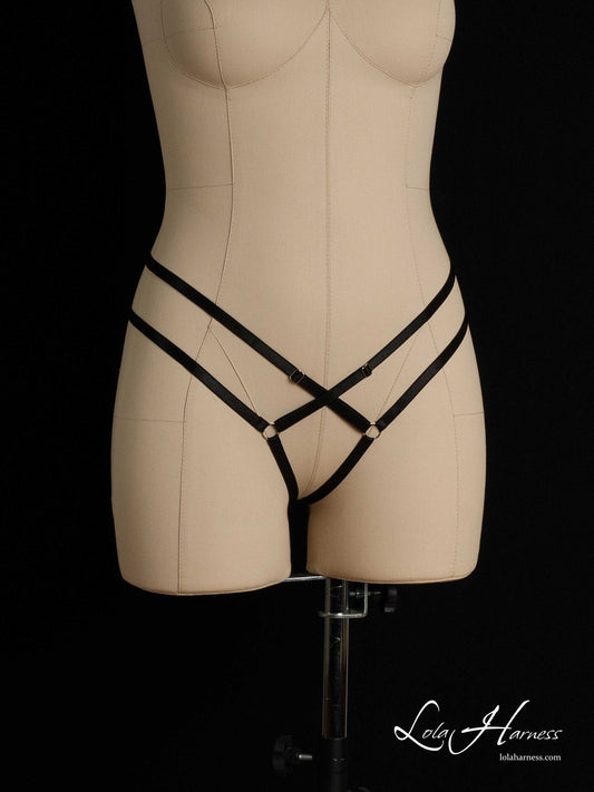 Front side view of The Candy harness panties on a mannequin in black, showcasing the ouvert design.
