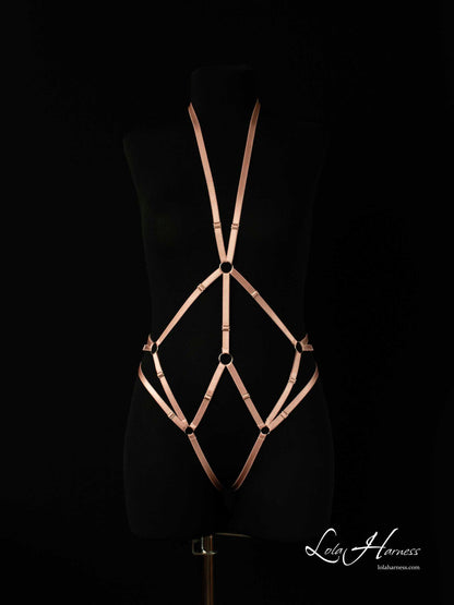 Front view of The Carry harness playsuit on a mannequin in dusty rose elastic, featuring an ouvert bodysuit with a neck strap that accentuates the waist and hips.