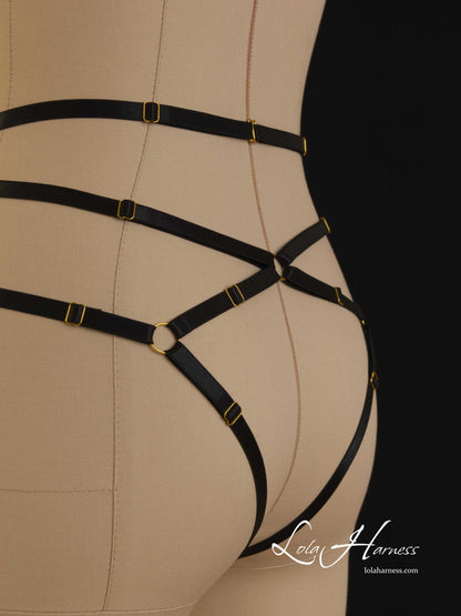 Close-up of the back view of The Darlene harness panties on a mannequin in black, emphasizing the hook closure and the ouvert style.