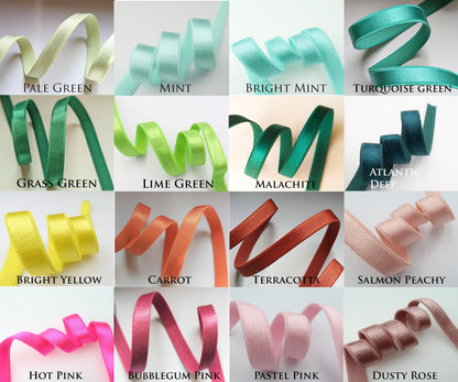 a bunch of different colors of satin ribbons